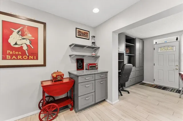 a kitchen with stainless steel appliances a stove a refrigerator cabinets dining table and chairs