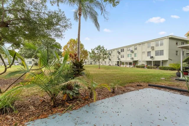 a backyard of a house with barbeque oven table and chairs