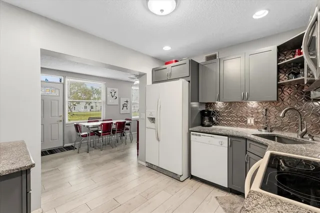 a kitchen with a refrigerator stove and sink