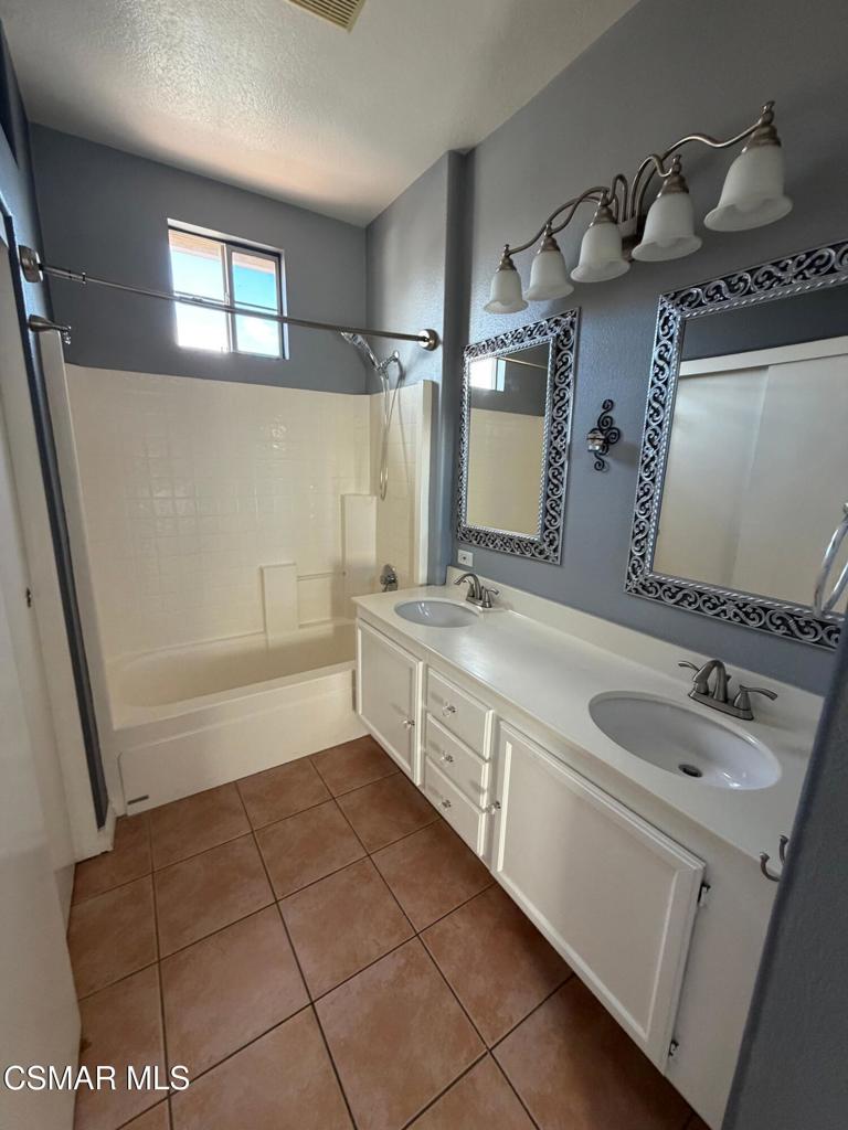 1961 Brookberry Lane Simi Valley, CA 93065 - Photo 13 of 23 a bathroom with a double vanity sink a mirror and a bathtub