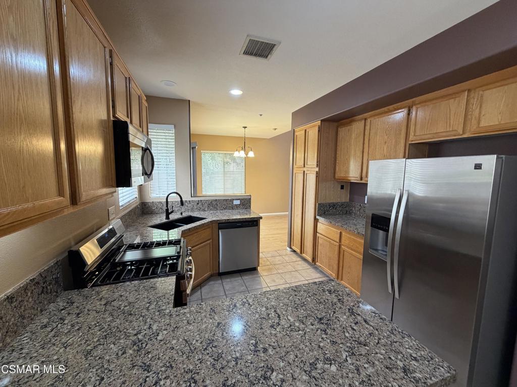1961 Brookberry Lane Simi Valley, CA 93065 - Photo 2 of 23 a large kitchen with a large window and stainless steel appliances