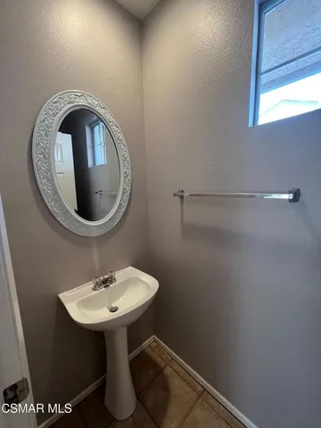a bathroom with a sink toilet and a mirror