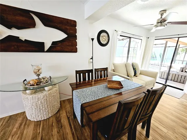 a dining room with furniture and wooden floor