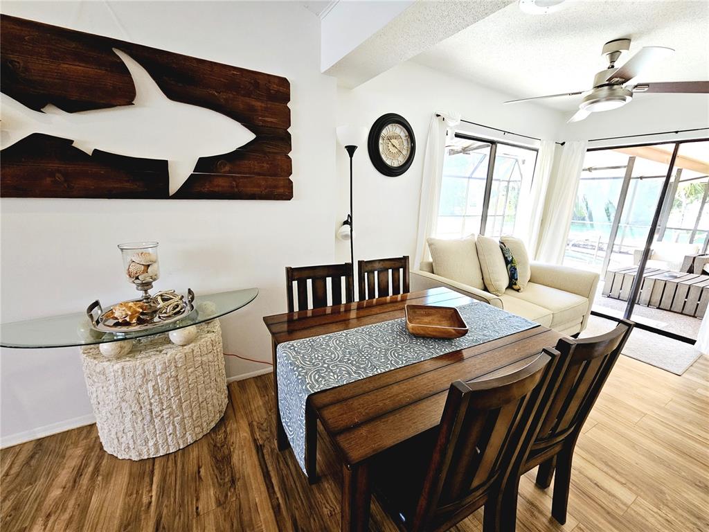 2411 Belle Road Englewood, FL 34223 - Photo 14 of 30 a view of a dining room with furniture and wooden floor