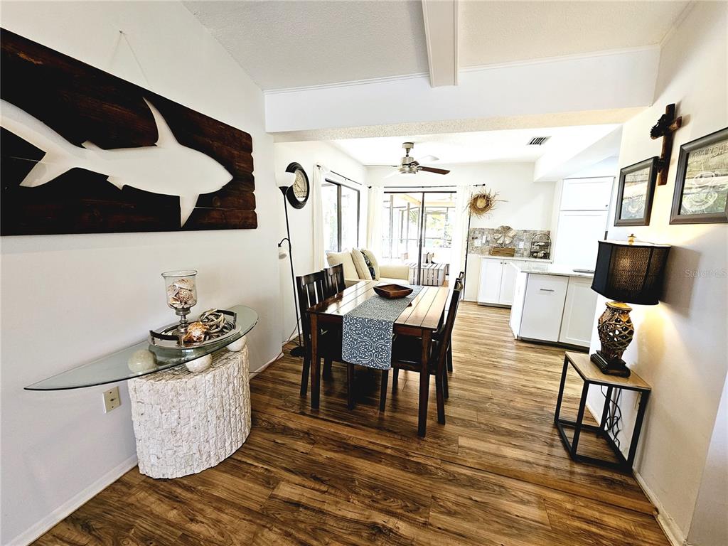 2411 Belle Road Englewood, FL 34223 - Photo 15 of 30 a dining room with furniture and wooden floor