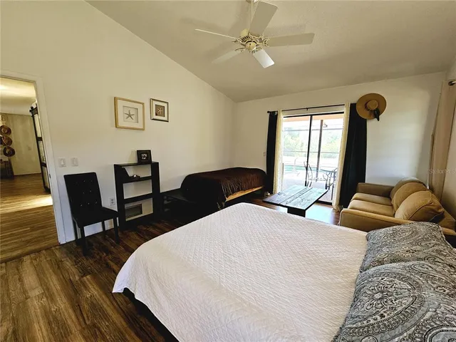 a bedroom with bed and wooden floor