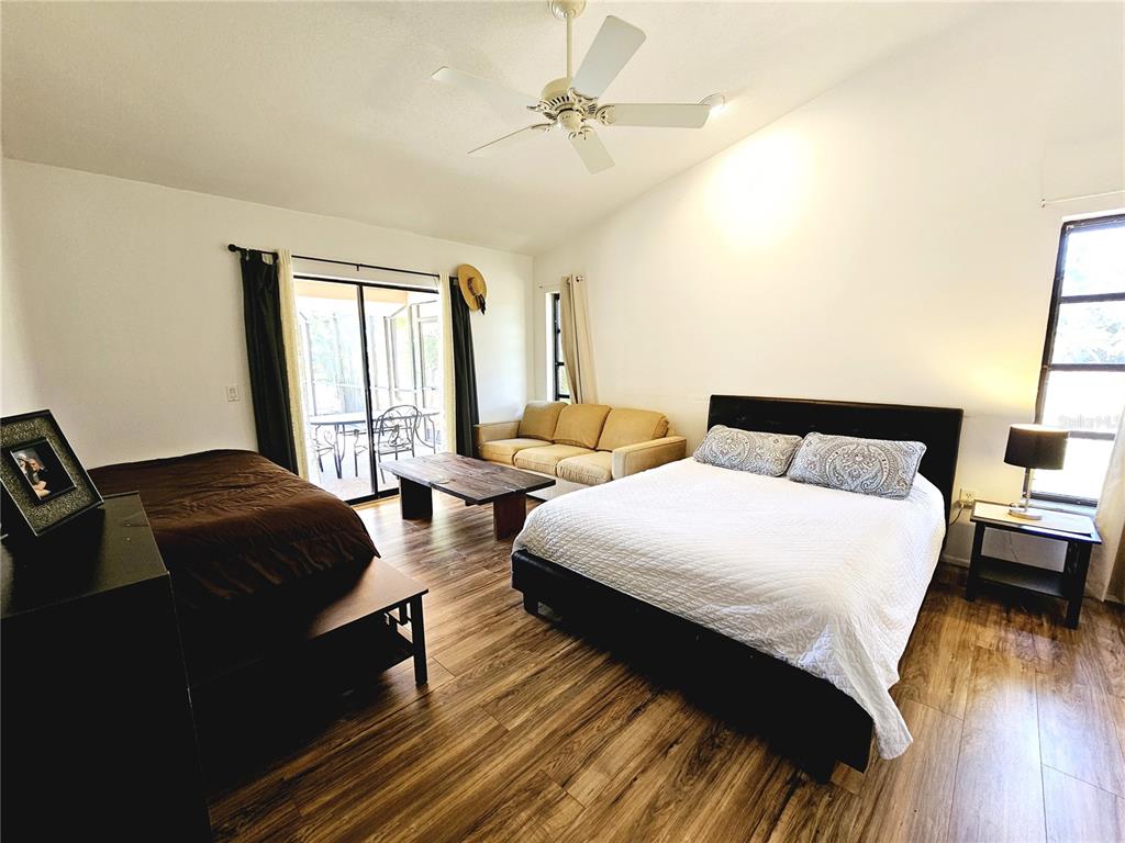 2411 Belle Road Englewood, FL 34223 - Photo 17 of 30 a bedroom with bed and wooden floor