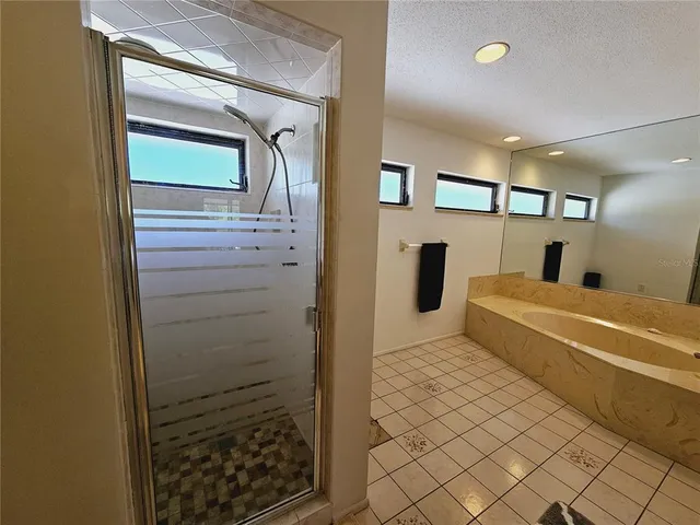 a bedroom with bed and wooden floor