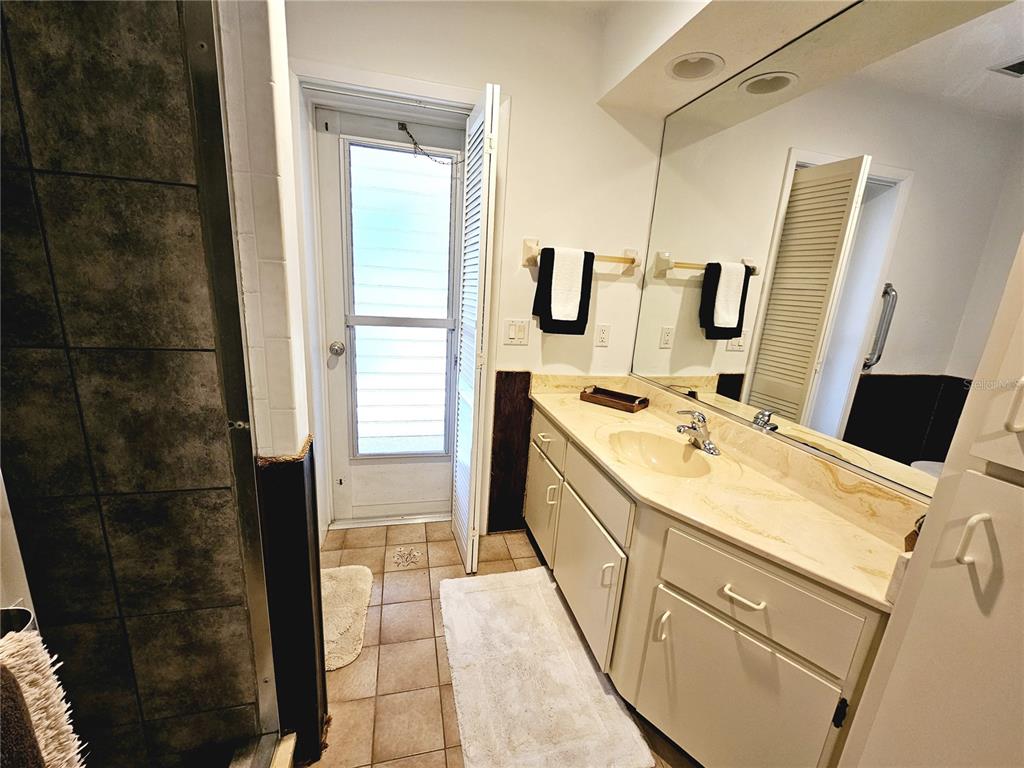 2411 Belle Road Englewood, FL 34223 - Photo 22 of 30 a bathroom with a double vanity sink a and mirror