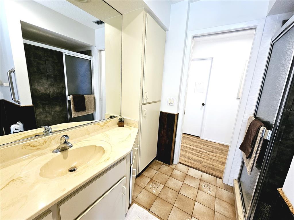 2411 Belle Road Englewood, FL 34223 - Photo 23 of 30 a bathroom with a sink and a mirror
