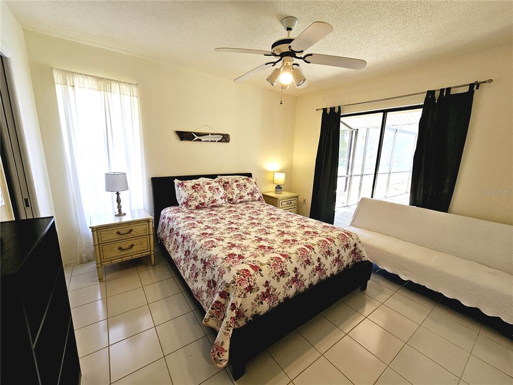2411 Belle Road Englewood, FL 34223 - Photo 24 of 30 a bedroom with a bed and a large mirror