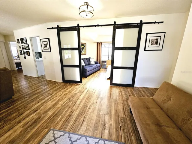 a view of front door with wooden floor and a window