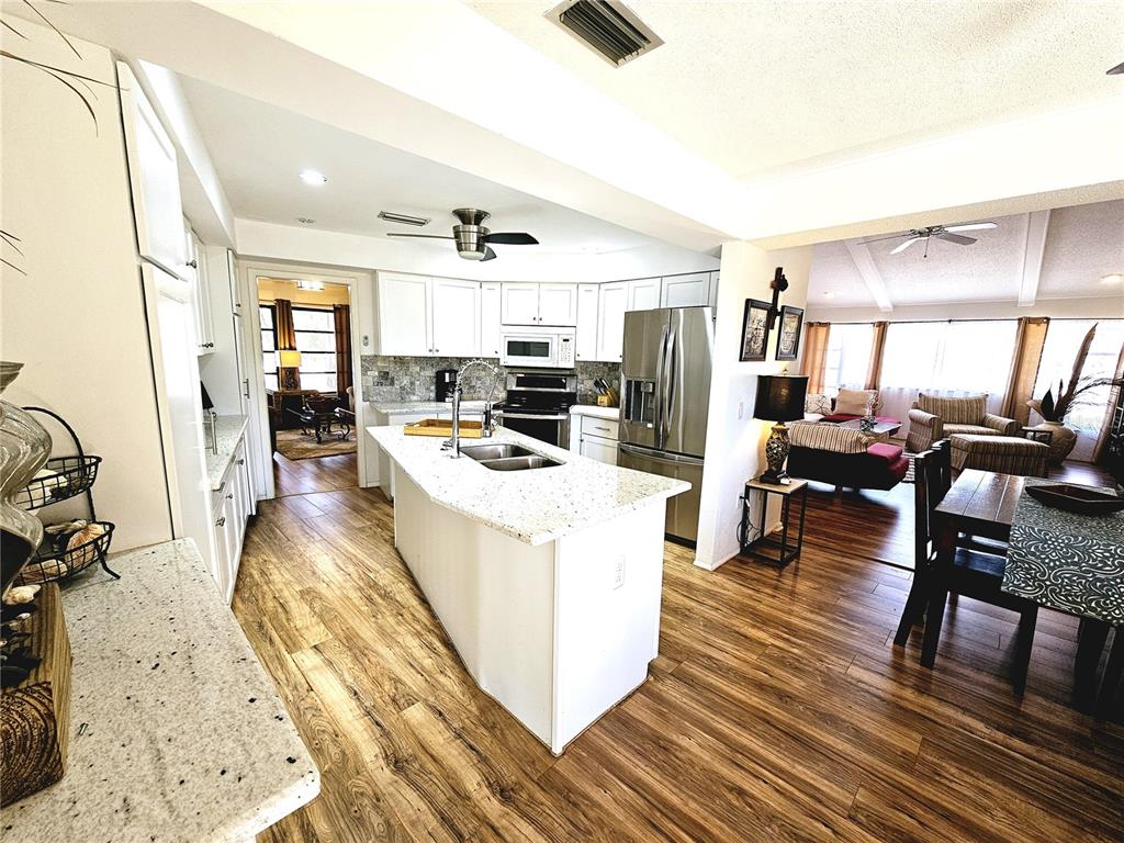 2411 Belle Road Englewood, FL 34223 - Photo 9 of 30 a living room with furniture and a flat screen tv
