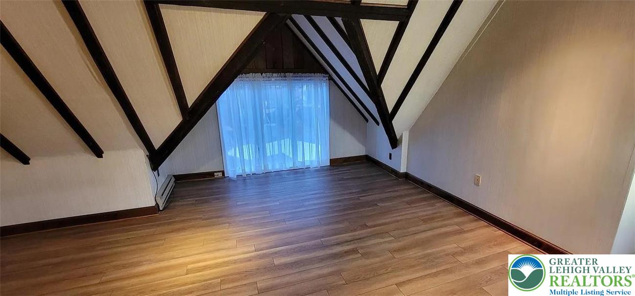 444 West 3rd Street, Unit 9 Bethlehem, PA 18015 - Photo 10 of 16 Exposed beams and wood-look flooring define this distinctive, well-lit attic space.