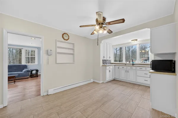 a view of a kitchen with furniture and a ceiling fan