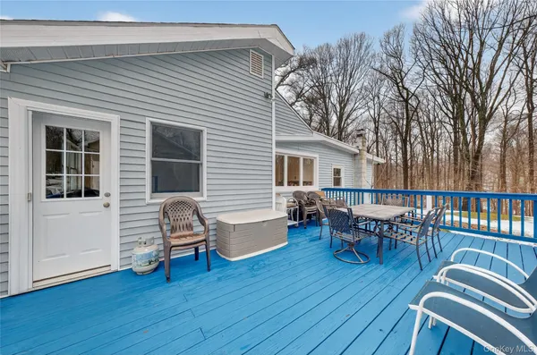 a view of a house with deck and outdoor seating