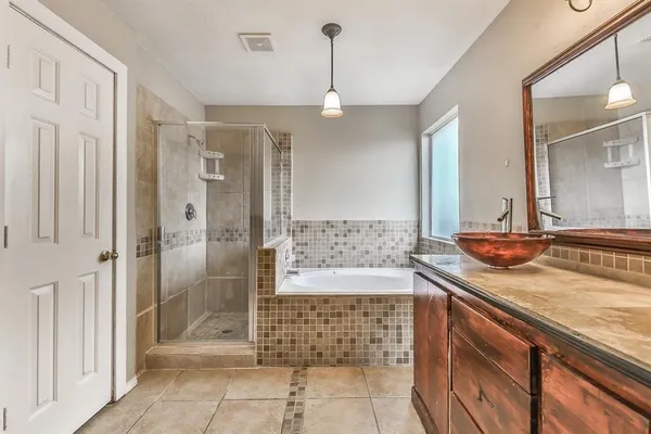 a bathroom with a granite countertop sink a toilet and shower