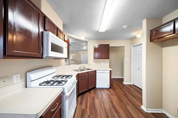 a kitchen with a sink and a stove top oven