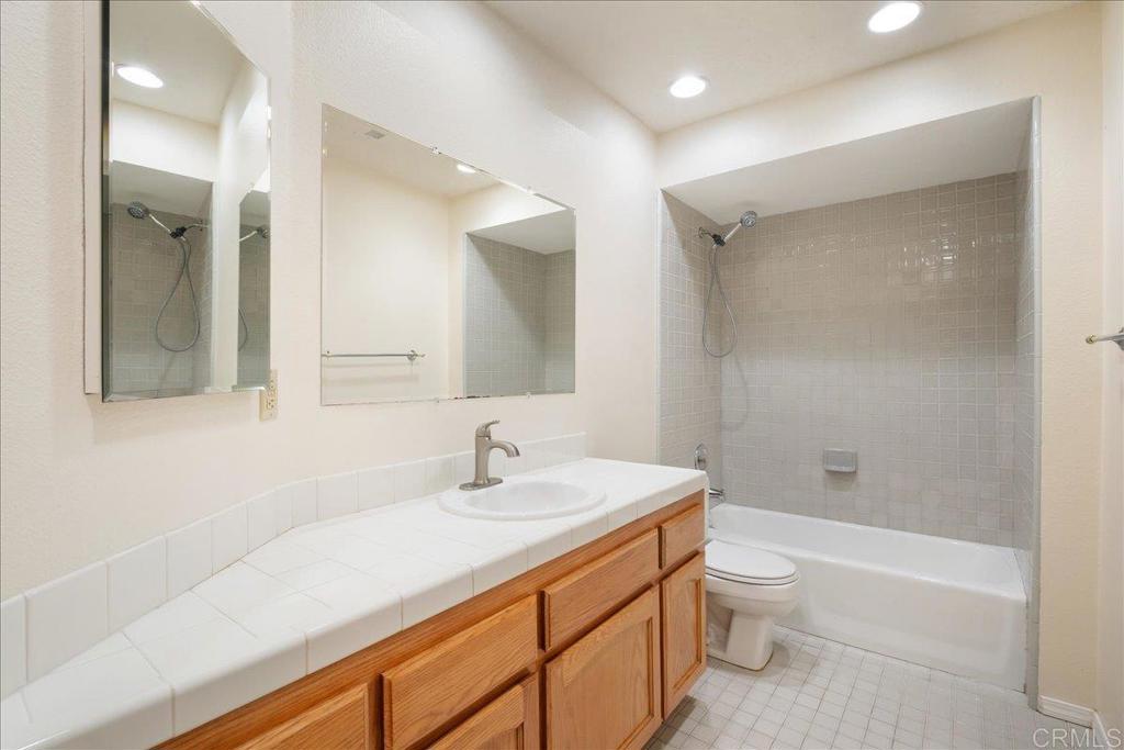 1617 Portola Avenue Spring Valley, CA 91977 - Photo 28 of 34 a bathroom with a sink a toilet and shower