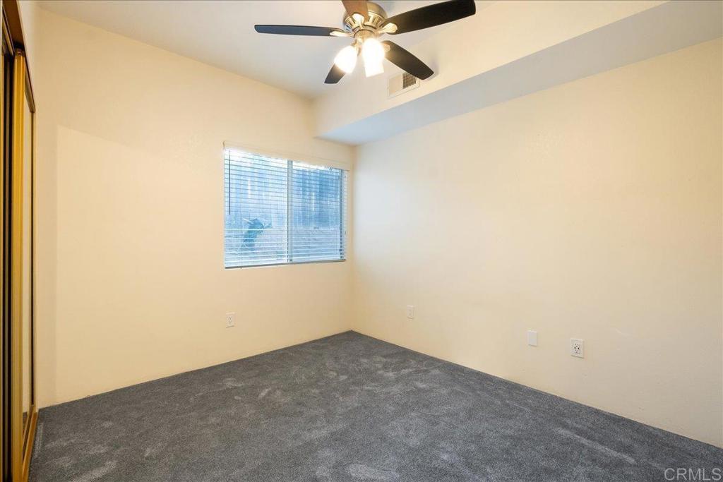 1617 Portola Avenue Spring Valley, CA 91977 - Photo 29 of 34 an empty room with a ceiling fan and a window