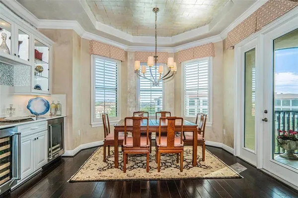 a dining room with wooden floor and breakfast area