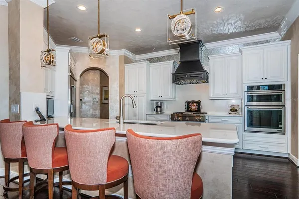 a bathroom with a granite countertop sink a mirror and a picture on the wall
