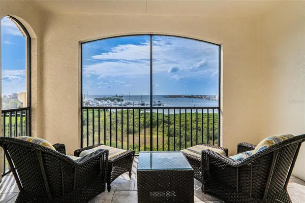a balcony with furniture and a table