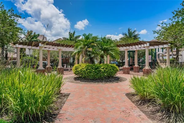 a front view of residential houses with yard and trees