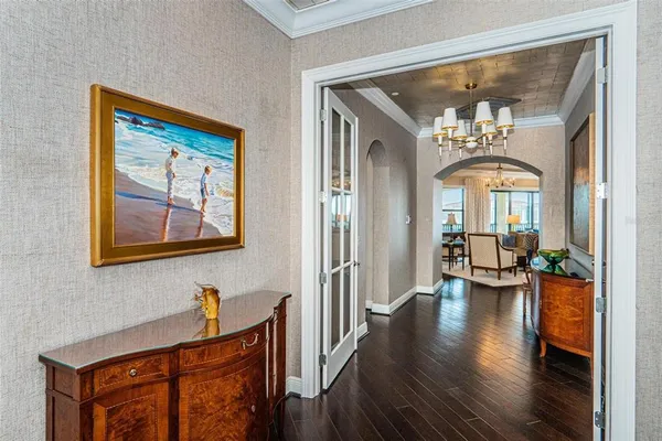 a view of a hallway with entryway wooden floor and front door