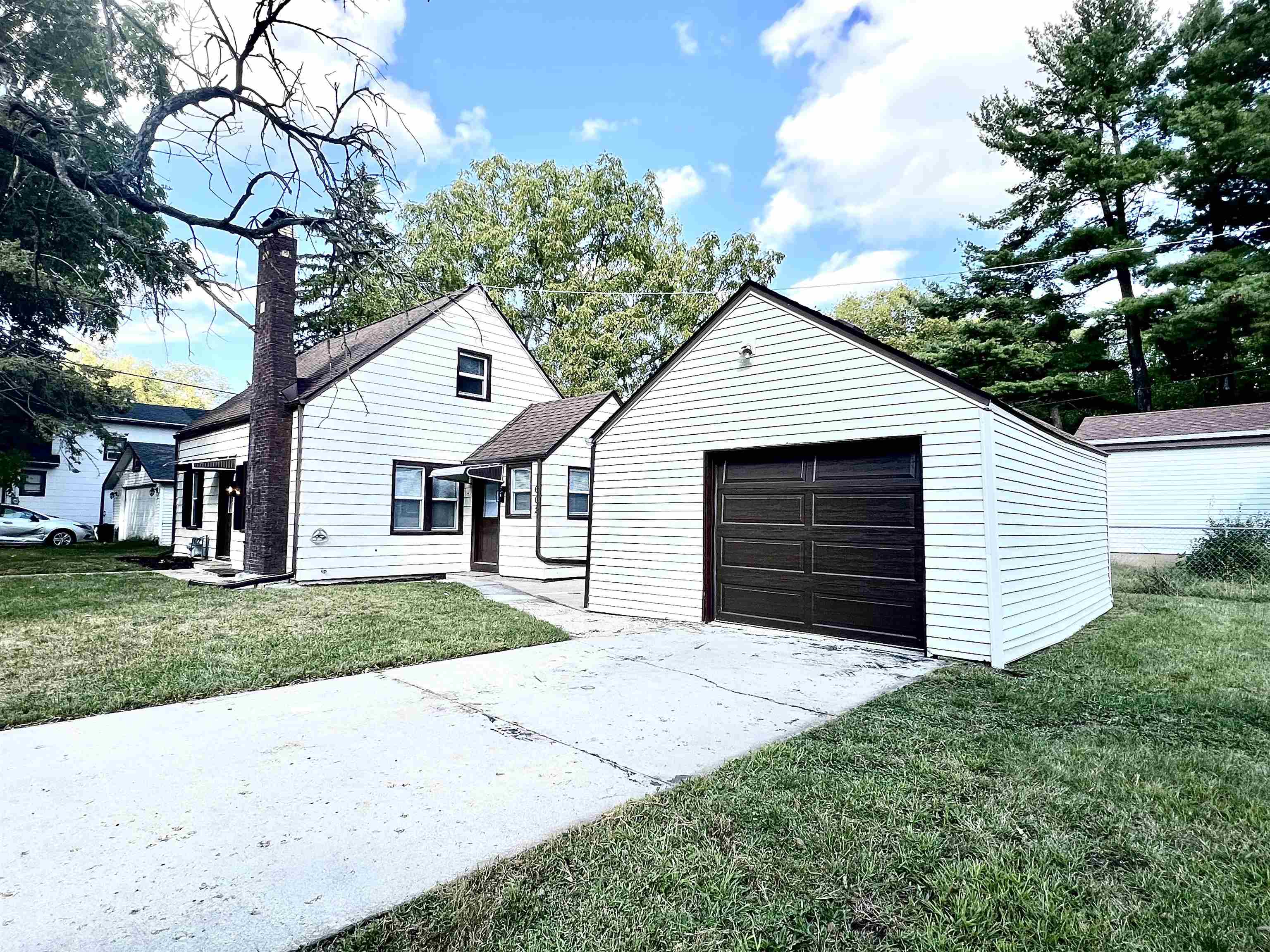 602 Barnum Road Rockford, IL 61109 - Photo 3 of 16 a front view of a house with a garden and trees