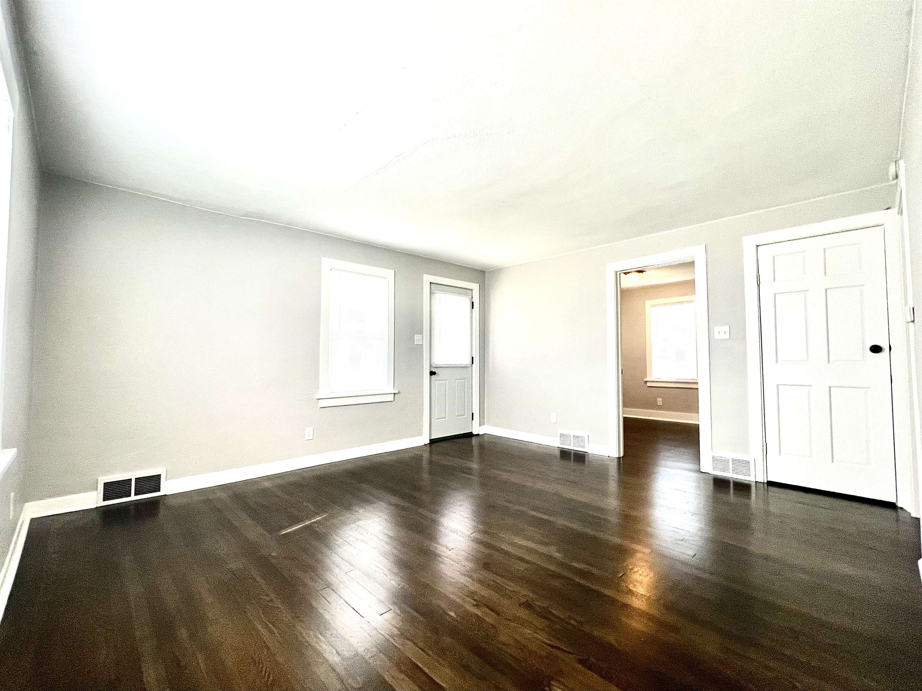 602 Barnum Road Rockford, IL 61109 - Photo 4 of 16 an empty room with wooden floor and windows