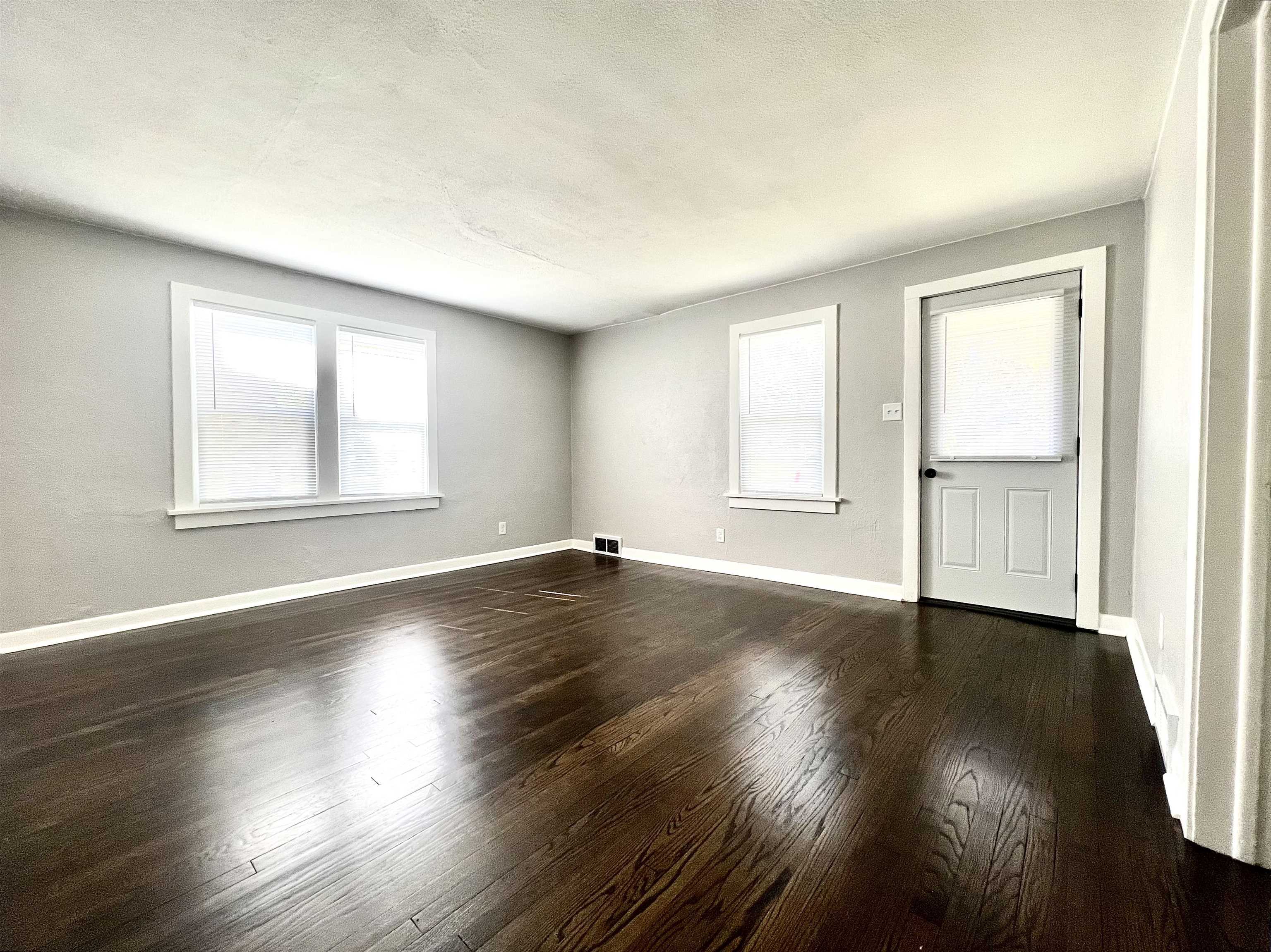 602 Barnum Road Rockford, IL 61109 - Photo 5 of 16 an empty room with wooden floor and windows