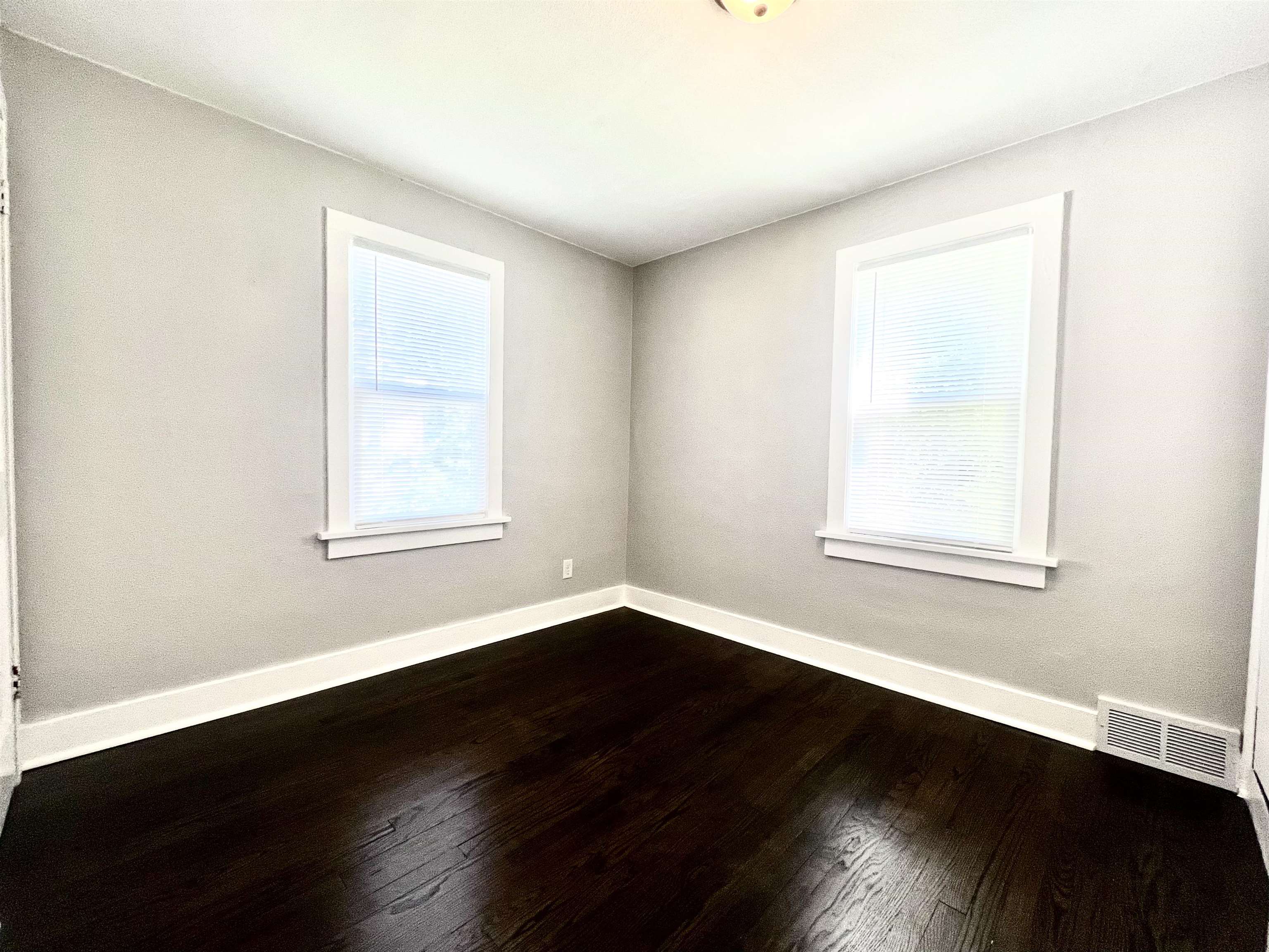602 Barnum Road Rockford, IL 61109 - Photo 6 of 16 a view of an empty room with wooden floor and a window