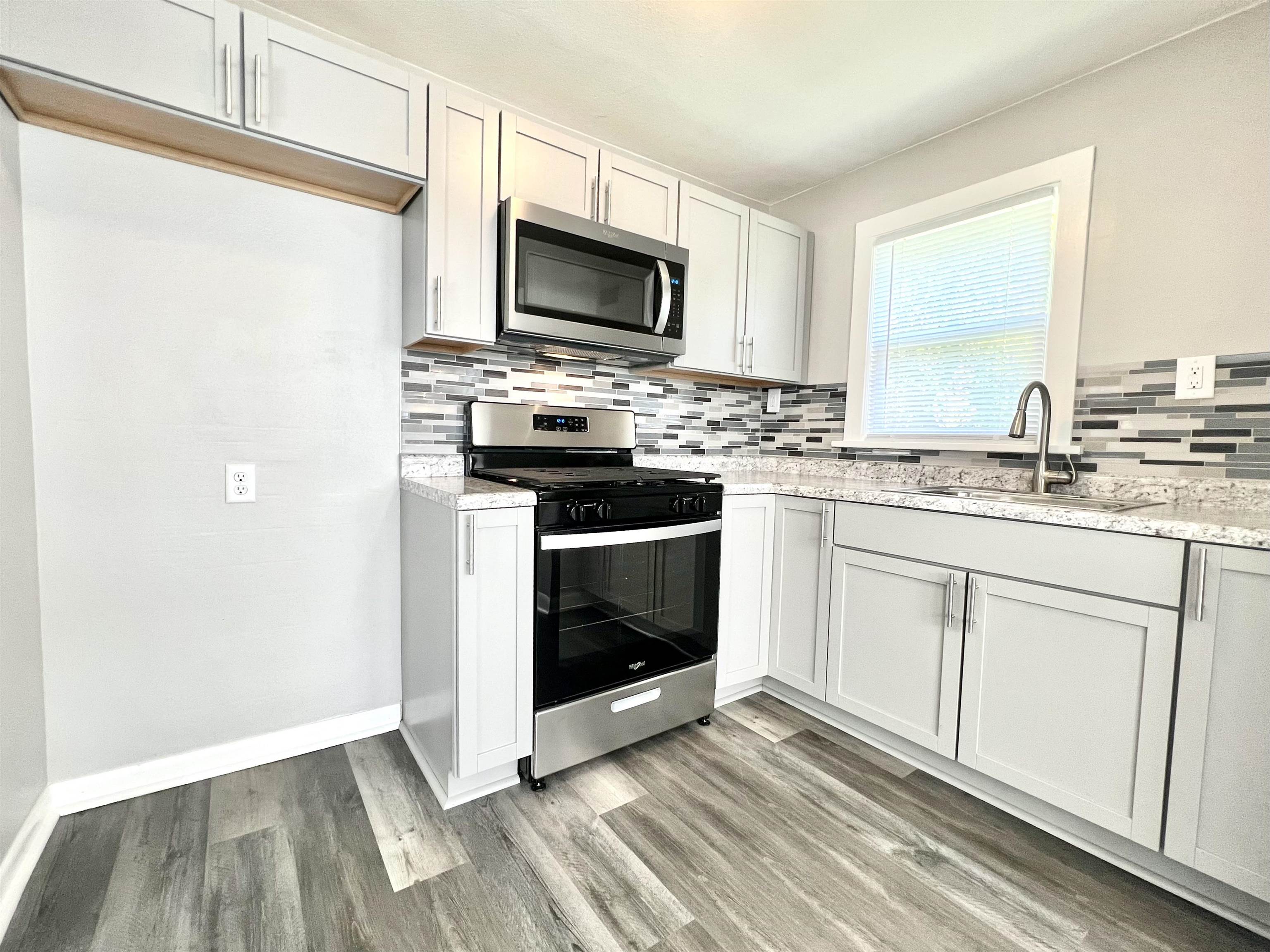 602 Barnum Road Rockford, IL 61109 - Photo 8 of 16 a kitchen with a stove microwave and sink
