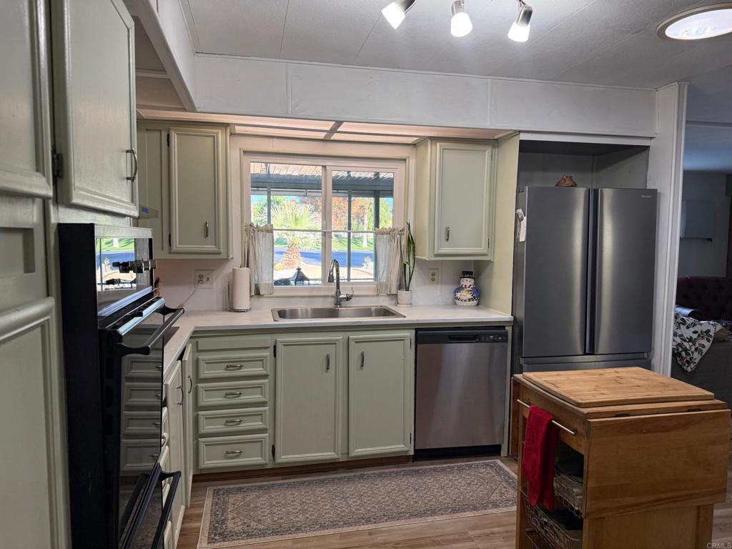 1010 Palm Canyon Drive, Unit 264 Borrego Springs, CA 92004 - Photo 11 of 50 a kitchen with kitchen island granite countertop a sink stove and refrigerator