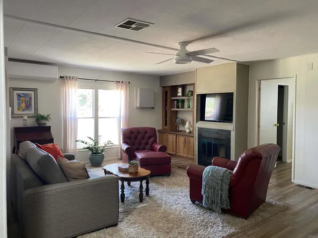 a living room with furniture flat screen tv and a fireplace