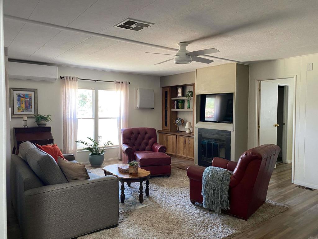 1010 Palm Canyon Drive, Unit 264 Borrego Springs, CA 92004 - Photo 15 of 50 a living room with furniture flat screen tv and a fireplace