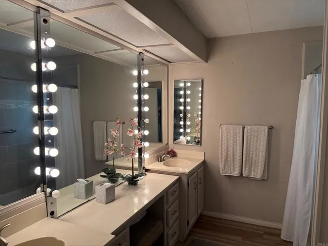 a bathroom with double vanity and two mirror