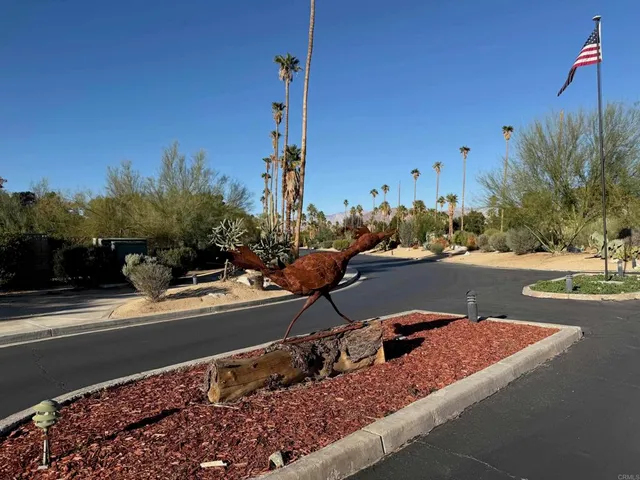 a view of a street with a park