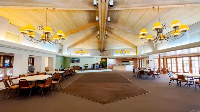 a living room with lots of furniture and a chandelier