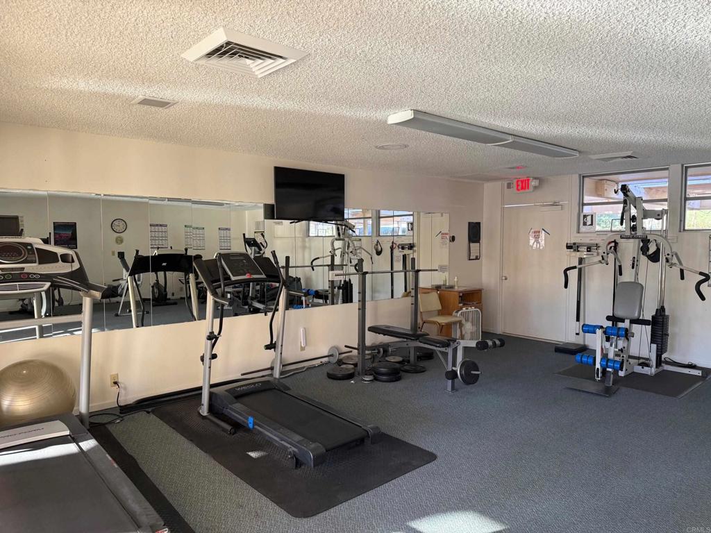1010 Palm Canyon Drive, Unit 264 Borrego Springs, CA 92004 - Photo 33 of 50 a living room with gym equipment and a table
