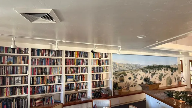 a view of wooden floor and a book shelf