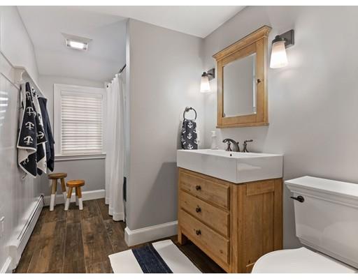 19 Woodridge Road Wellesley, MA 02482 - Photo 25 of 34 a bathroom with a sink a toilet a mirror and shower