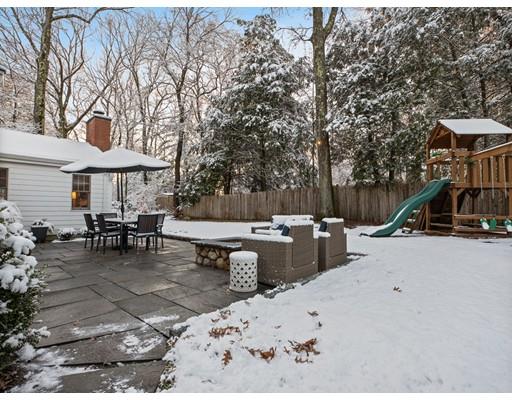 19 Woodridge Road Wellesley, MA 02482 - Photo 29 of 34 a view of a patio with a table and chairs under an umbrella