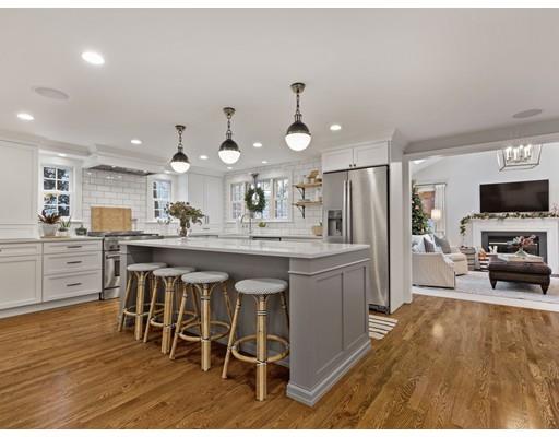 19 Woodridge Road Wellesley, MA 02482 - Photo 7 of 34 a kitchen with stainless steel appliances kitchen island granite countertop a table chairs sink and cabinets