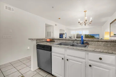 a kitchen with stainless steel appliances granite countertop a sink and cabinets
