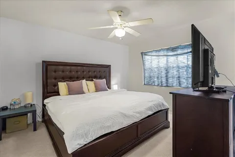 a bedroom with a bed and a window