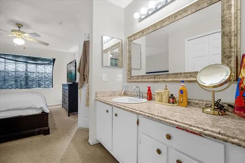 a en suite bathroom with a double vanity sink and a mirror