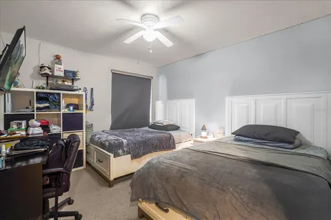 a bedroom with two beds and a chandelier
