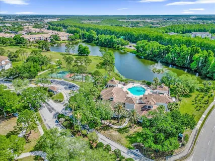 an aerial view of residential houses with outdoor space and lake view